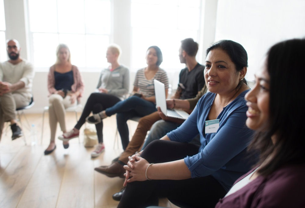 mental-illness-hereditary-factors woman wearing nametag at group therapy session