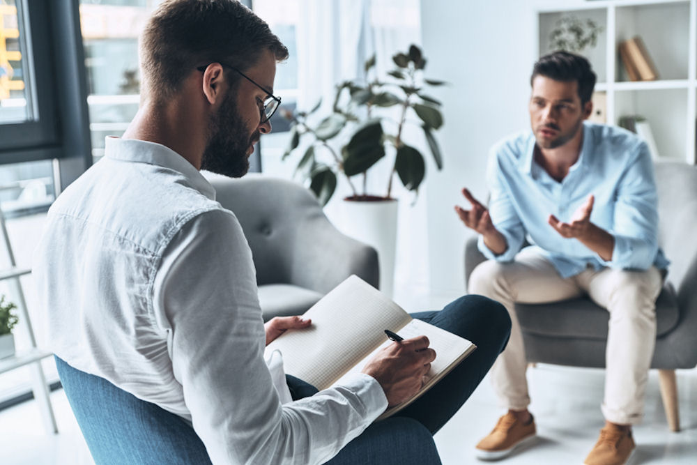Man in one-on-one session with therapist for Sober Living