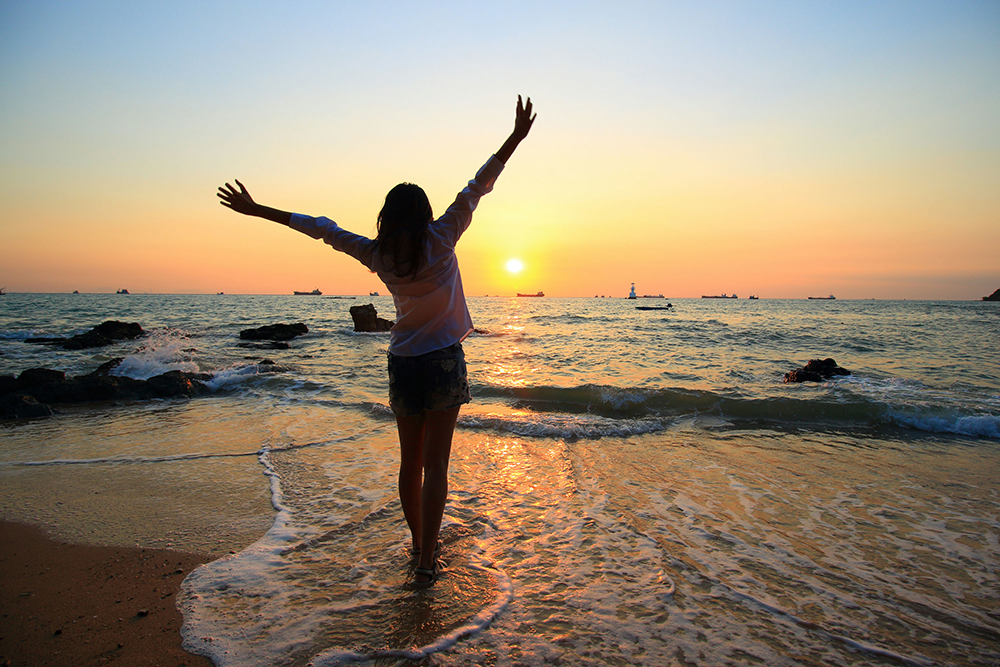 ndividual raising arms at sunrise, representing empowerment and confidence gained through motivational interviewing for recovery.
