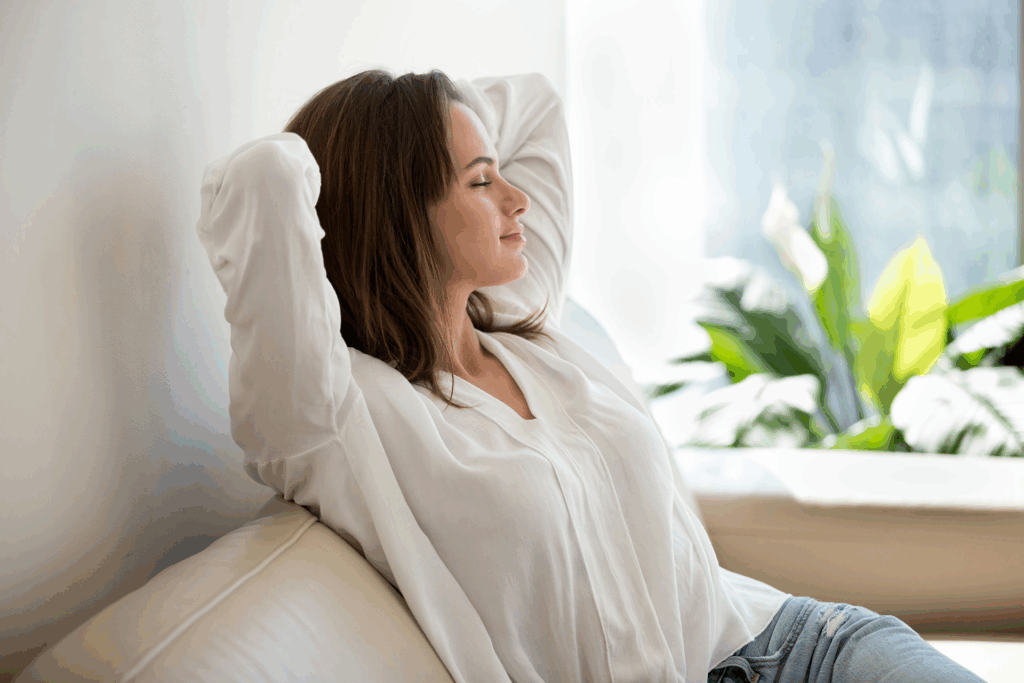 woman relaxing in a supportive recovery housing environment, representing the difference between halfway houses and sober living homes.
