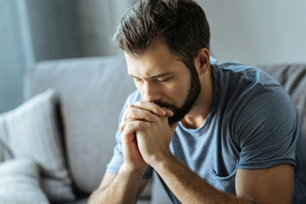 man sitting quietly, reflecting calmly as a symbol of emotional sobriety and inner balance in recovery