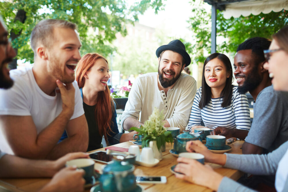 Group of friends enjoying coffee and conversation at a cozy New Jersey cafe without alcohol