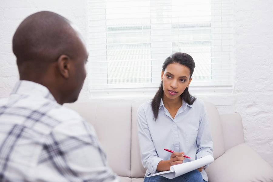Behavioral health professional completing an addiction treatment assessment with a client
