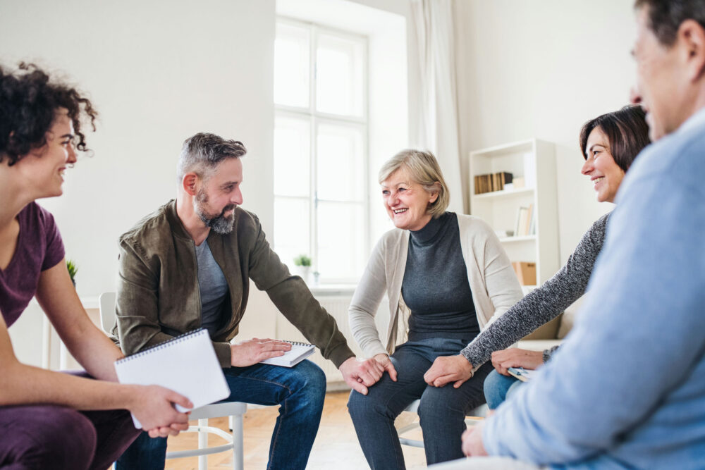 Individuals participating in a supportive addiction recovery group therapy session.