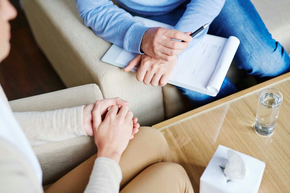 Counselor explaining a Partial Hospitalization Program schedule to a client