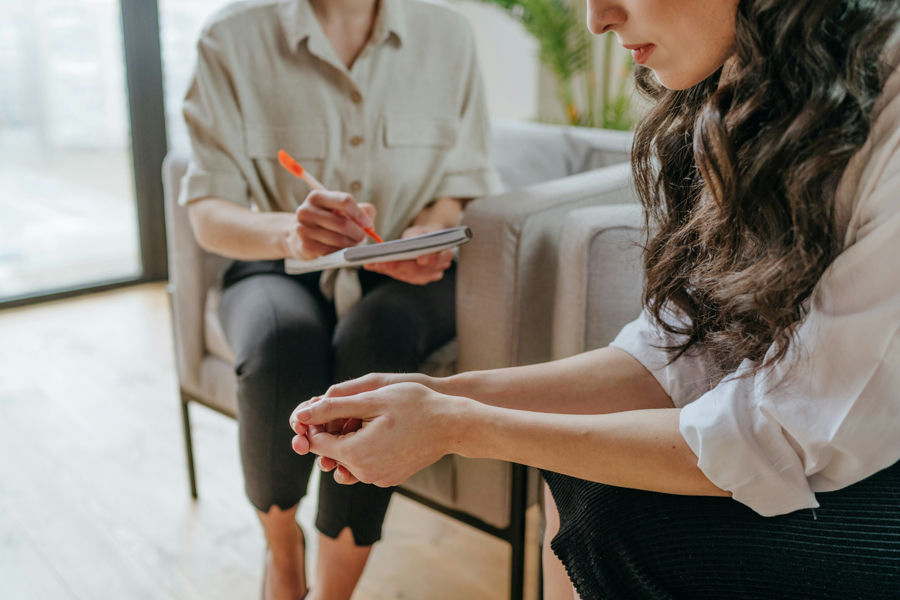 Therapist providing compassionate support to a client discussing psychological dependence.